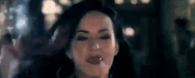 a close up of a woman making a funny face with her mouth open .