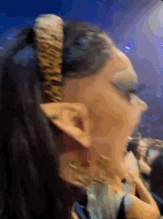 a close up of a woman wearing a headband with horns .