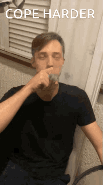 a man in a black shirt is smoking a cigarette with the words cope harder below him