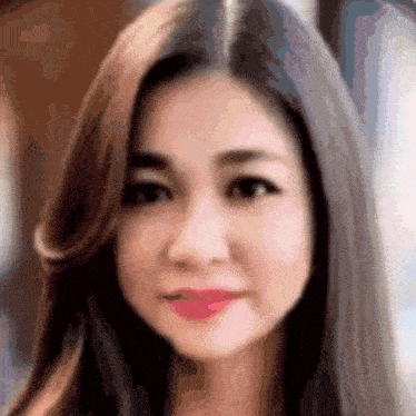 a blurry picture of a woman 's face with long hair and red lips