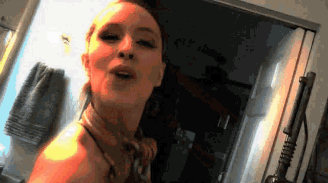a woman is taking a picture of herself in a bathroom mirror