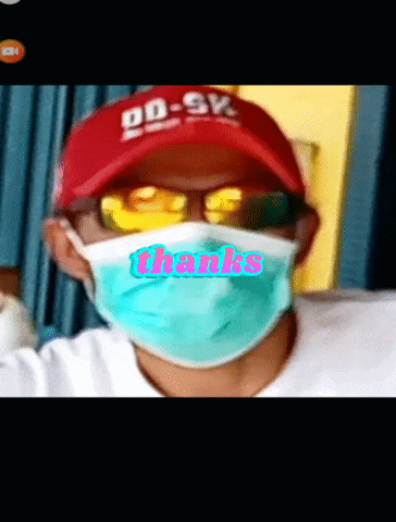 a man wearing a red hat and sunglasses is wearing a mask that says thanks on it