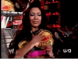 a woman in a wrestling outfit is holding a fan in front of a usa sign