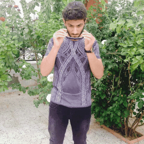 a man wearing a purple shirt with a pattern on it