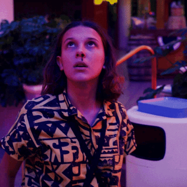 a girl wearing a shirt that says ' nb ' on it