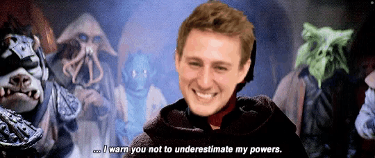 a man is smiling in front of a group of monsters and says i warn you not to underestimate my powers