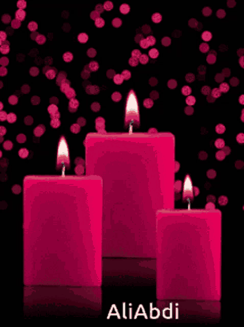 three pink candles on a black background with the name aliabdi at the bottom
