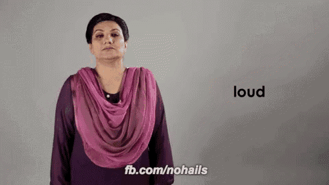 a woman wearing a pink scarf and a purple shirt says loud