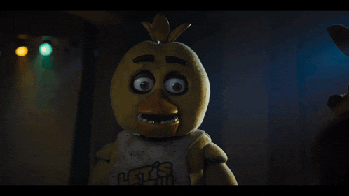 a stuffed chicken wearing a shirt that says let 's