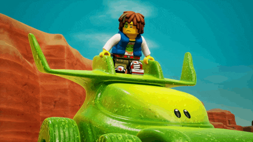 a lego figure is sitting on top of a green toy car