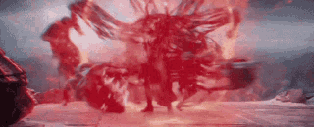 a person is standing in front of a large red explosion .