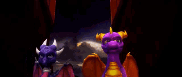 two purple dragons standing next to each other in a dark room