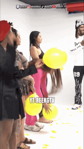 a group of people are playing with yellow balloons and yt-reekgtv is written on the bottom