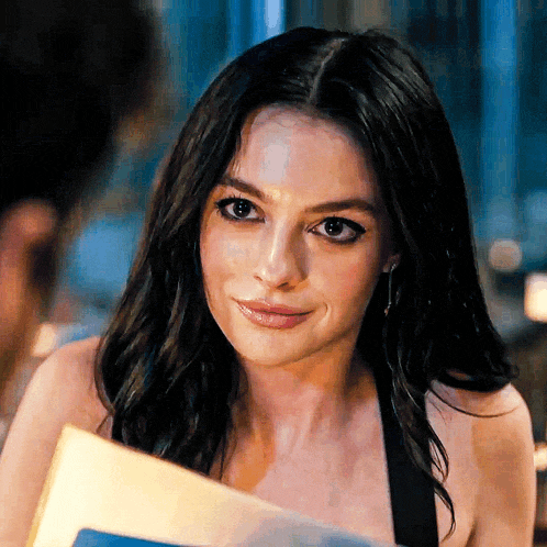 a close up of a woman holding a book
