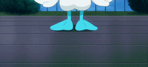 a white duck with blue eyes and a yellow beak is standing on a railing