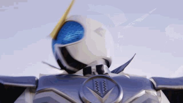 a close up of a robot 's head with a blue and yellow helmet