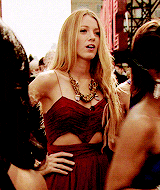 a woman in a red dress with a necklace on her neck