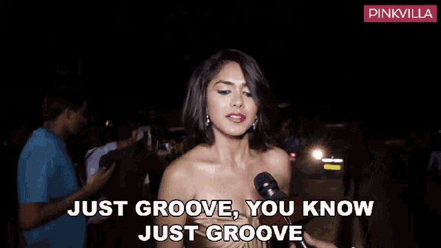 a woman is talking into a microphone with the words just groove you know just groove