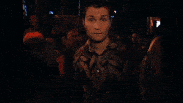 a blurry picture of a man 's face with a woman behind him