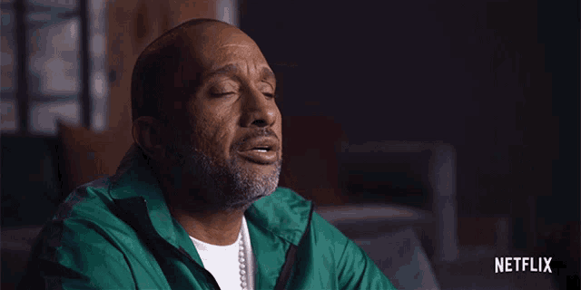 a man in a green jacket with netflix written on the bottom right
