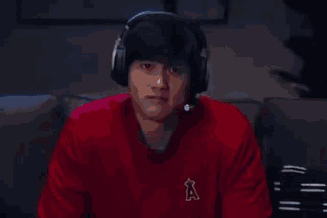 a man wearing headphones is sitting on a couch .