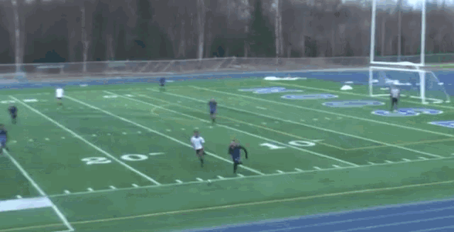 a group of people are playing soccer on a field with the number 30 on it