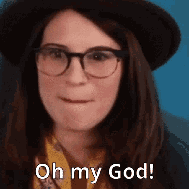 a woman wearing glasses and a hat is saying oh my god