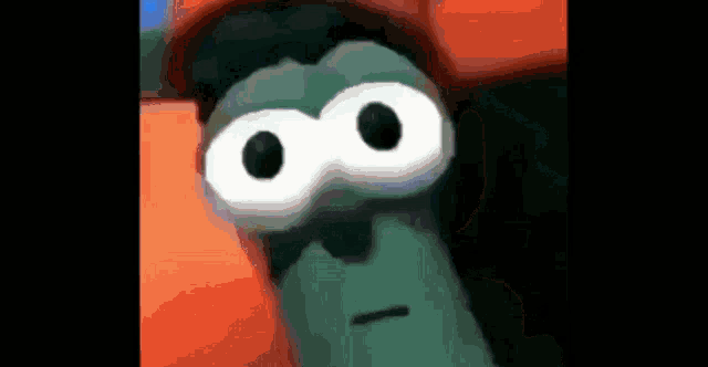 a close up of a cartoon character 's face with big white eyes