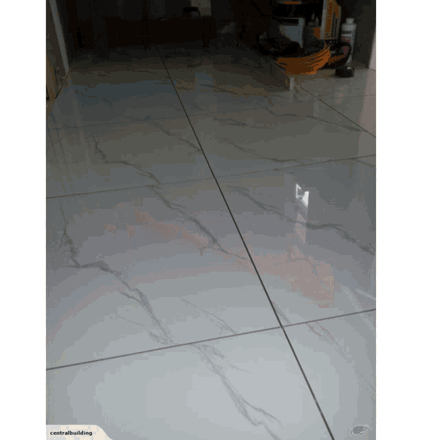 a picture of a white tiled floor with the words centralbuilding on the bottom right