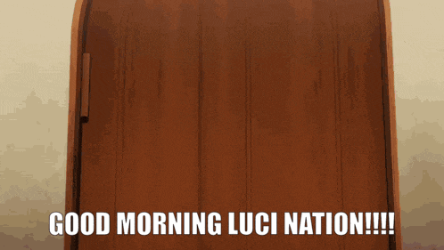 a wooden door with the words " good morning luci nation " written on it