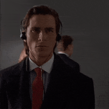a man in a suit and tie is wearing headphones