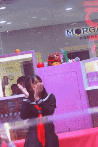 a woman stands in front of a store that says morgan home