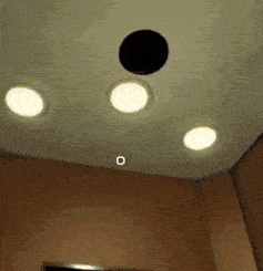 a ceiling with three lights and a circle in the middle of it