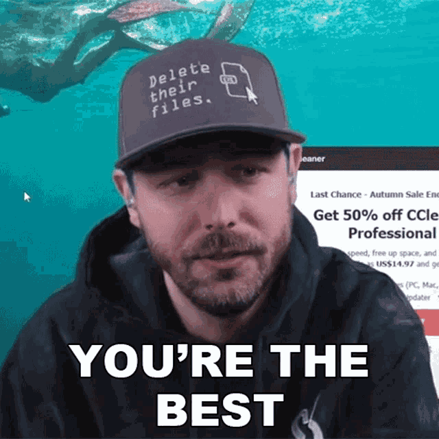 a man wearing a hat that says " delete their files "