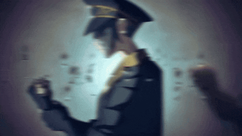 a blurry picture of a man in a hat and tie