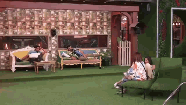 a group of people are sitting on couch in a room