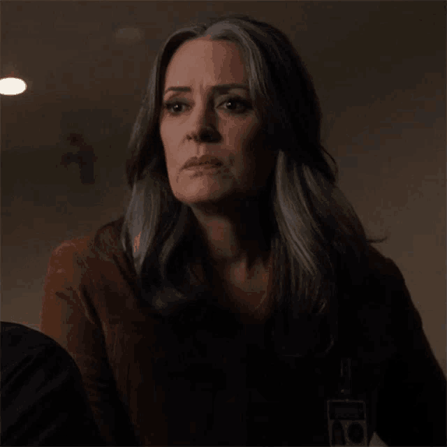 a woman with gray hair and a brown shirt says what was that