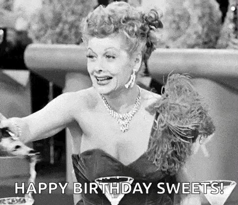 a black and white photo of a woman in a dress holding a martini glass and saying `` happy birthday sweets '' .