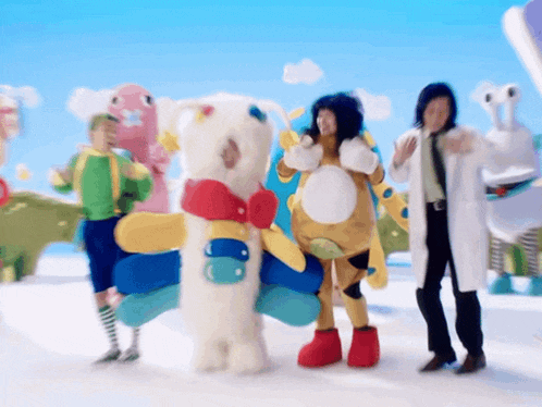 a group of people dressed in costumes are standing in a snowy area