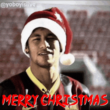 a man wearing a santa hat says merry christmas in red letters