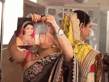 a woman is holding a picture of another woman
