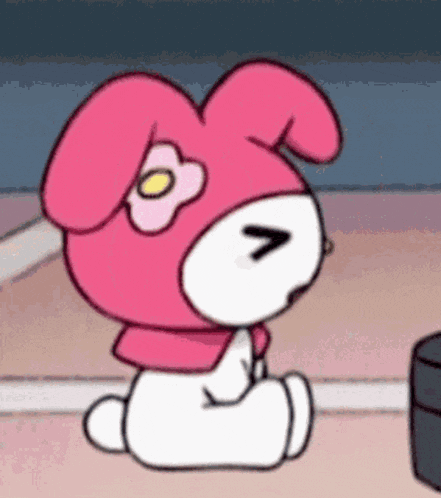 a pink and white bunny with a flower on its head is sitting on the floor with its eyes closed .