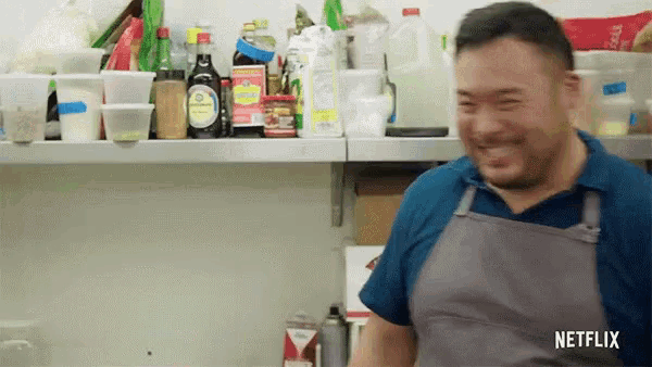 a man in an apron is smiling in a kitchen with netflix written on the bottom right corner