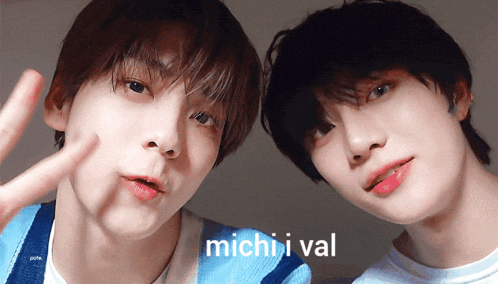 two young men are posing for a picture and the words michii val are on the bottom right