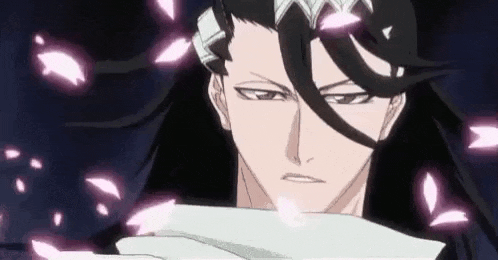 a close up of a person 's face with pink petals coming out of his hair .