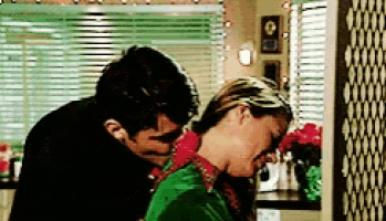 a man is hugging a woman in a green shirt
