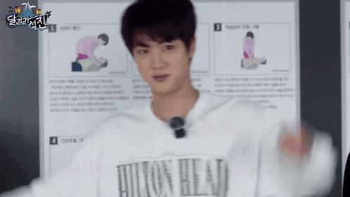a man wearing a white shirt with the word hilton on it