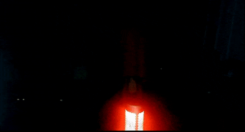a person is holding a red object in their hand