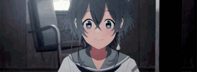 a girl with blue hair is smiling and wearing earbuds