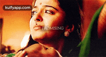 a close up of a woman 's face with the words promising on the bottom .